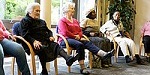 Group of elderly people doing leg exercises